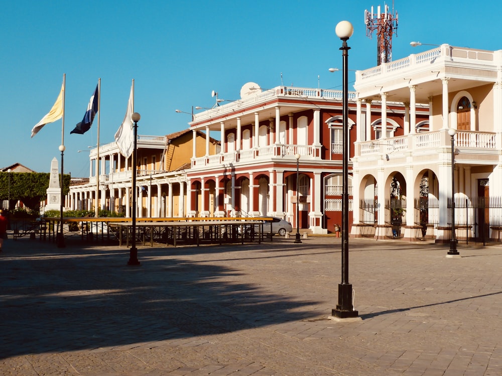 white concrete building with flags on top during daytime