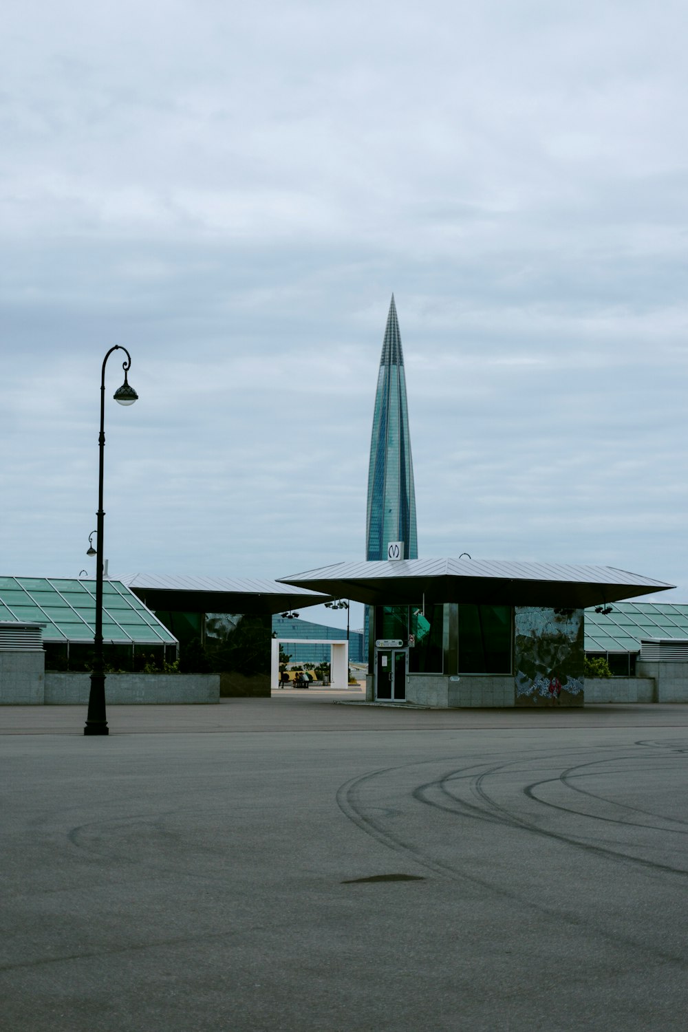 green and white concrete building under gray sky