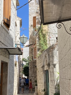 A group walking through the ancient medina of Fes, with narrow alleys and historic architecture.