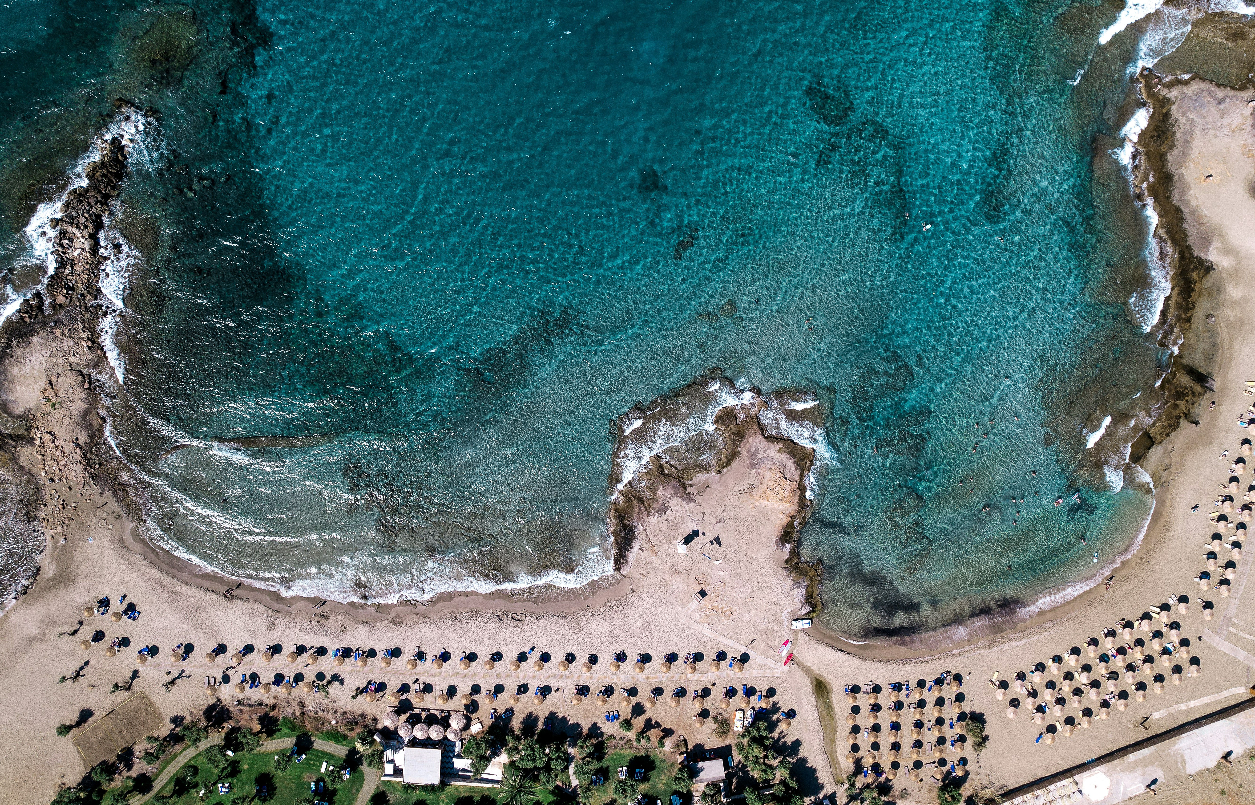 aerial view of people on beach during daytime, beach in front of Cretan Malia Park