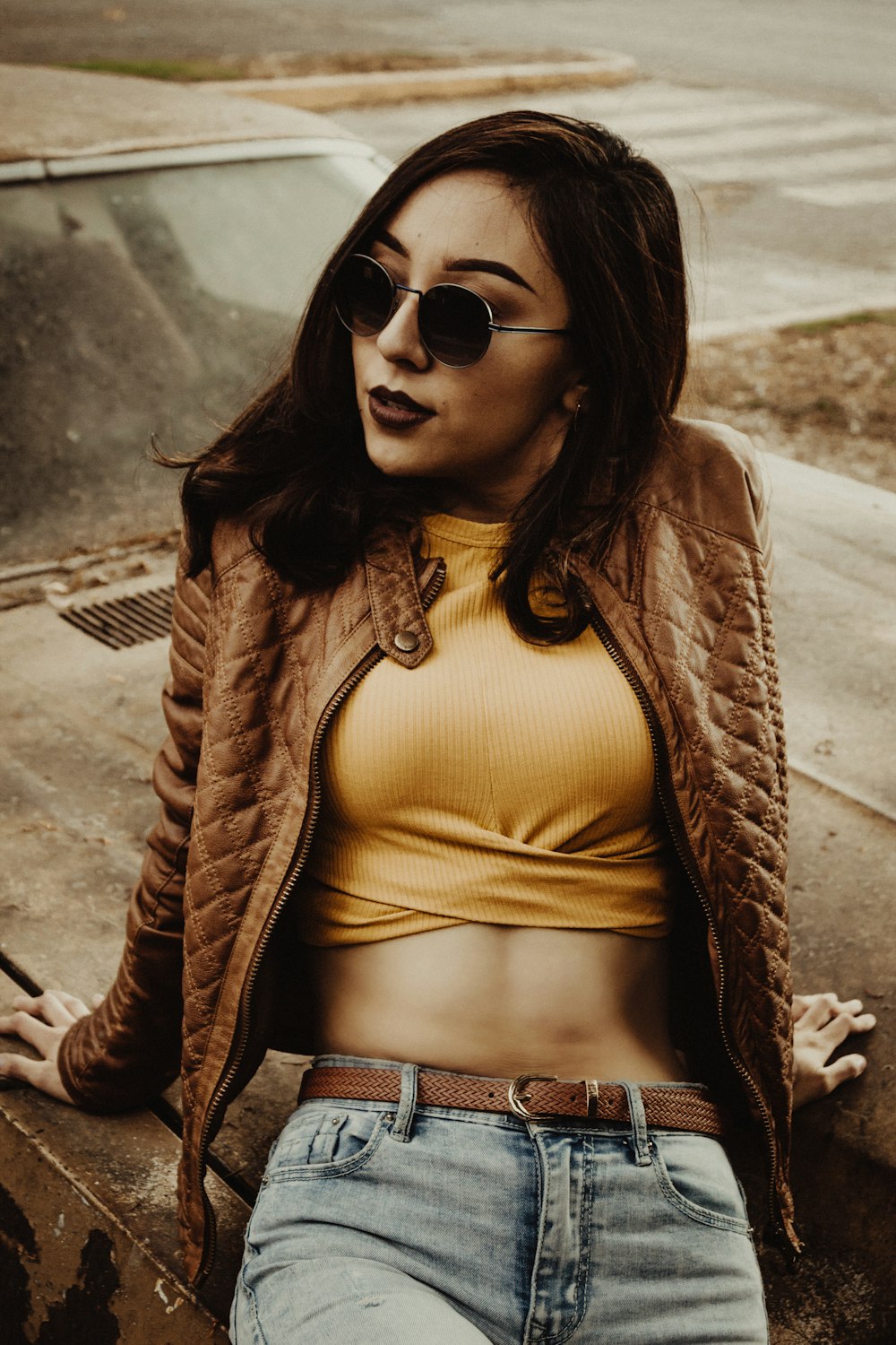woman in brown jacket and white crop top