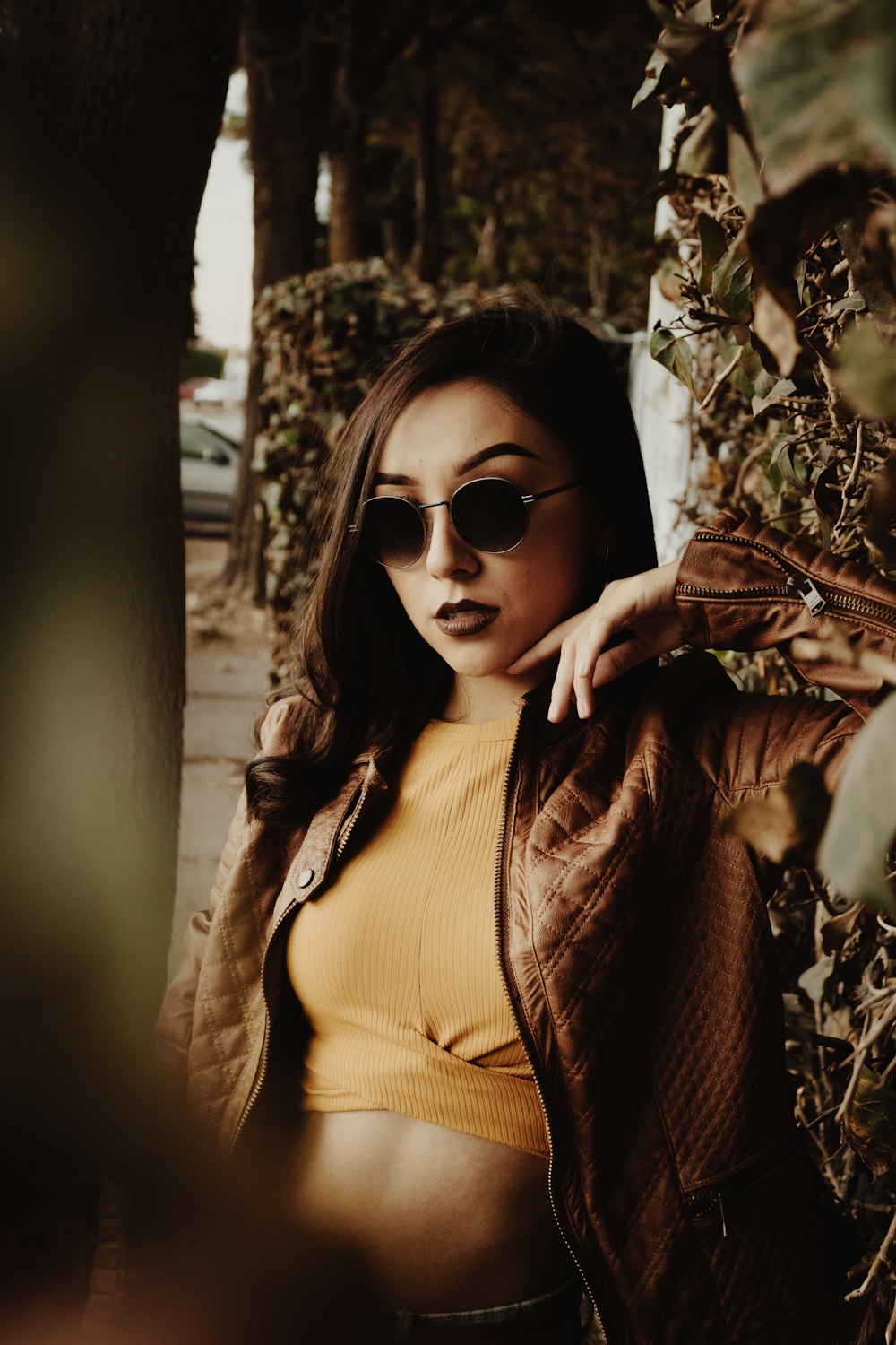 woman in brown coat wearing black sunglasses