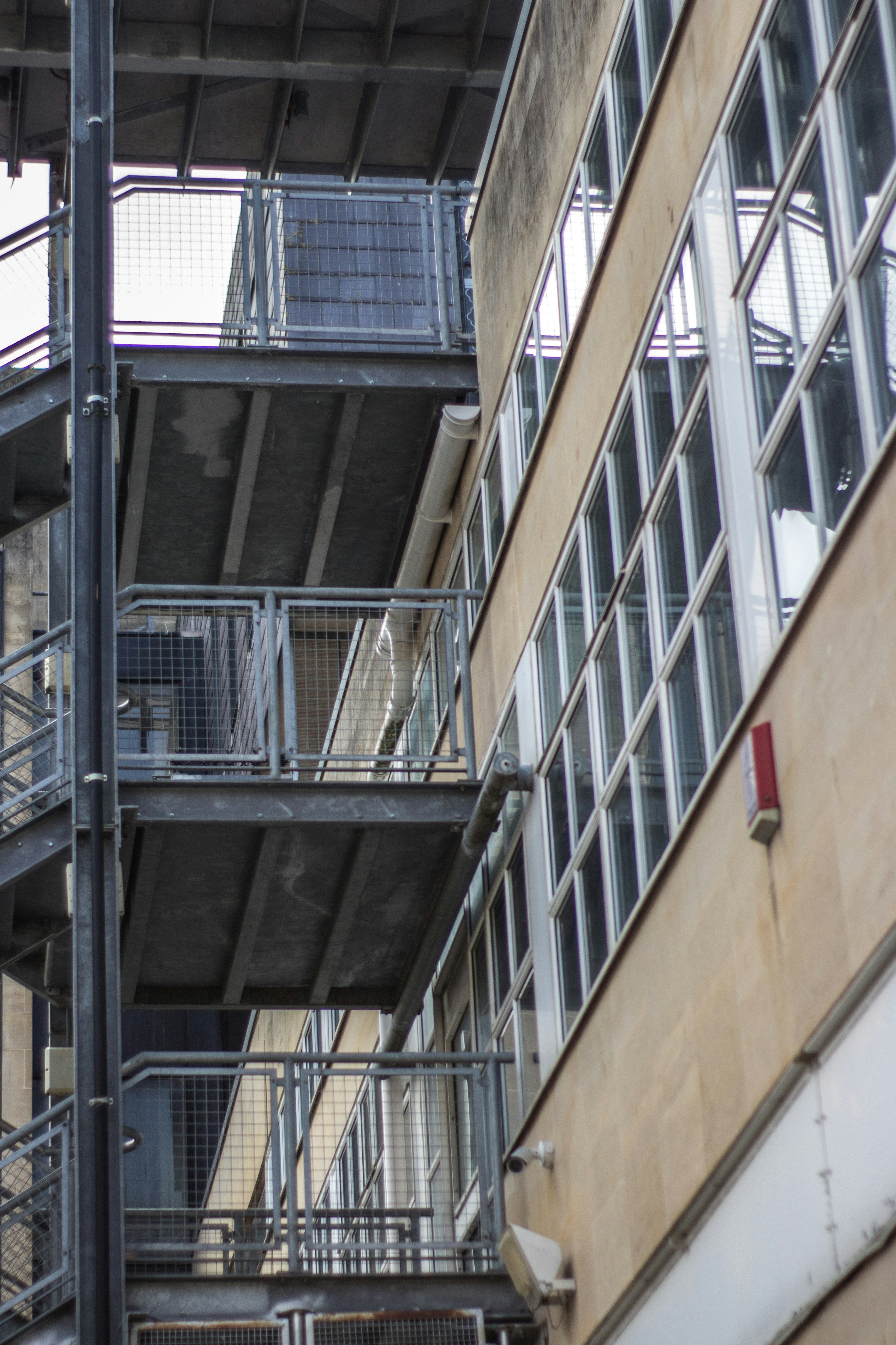 black metal staircase near brown concrete building
