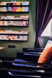 An inviting reading nook with eco-conscious books stacked on a natural wood shelf.