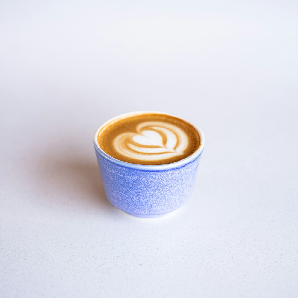 blue and white ceramic mug with coffee