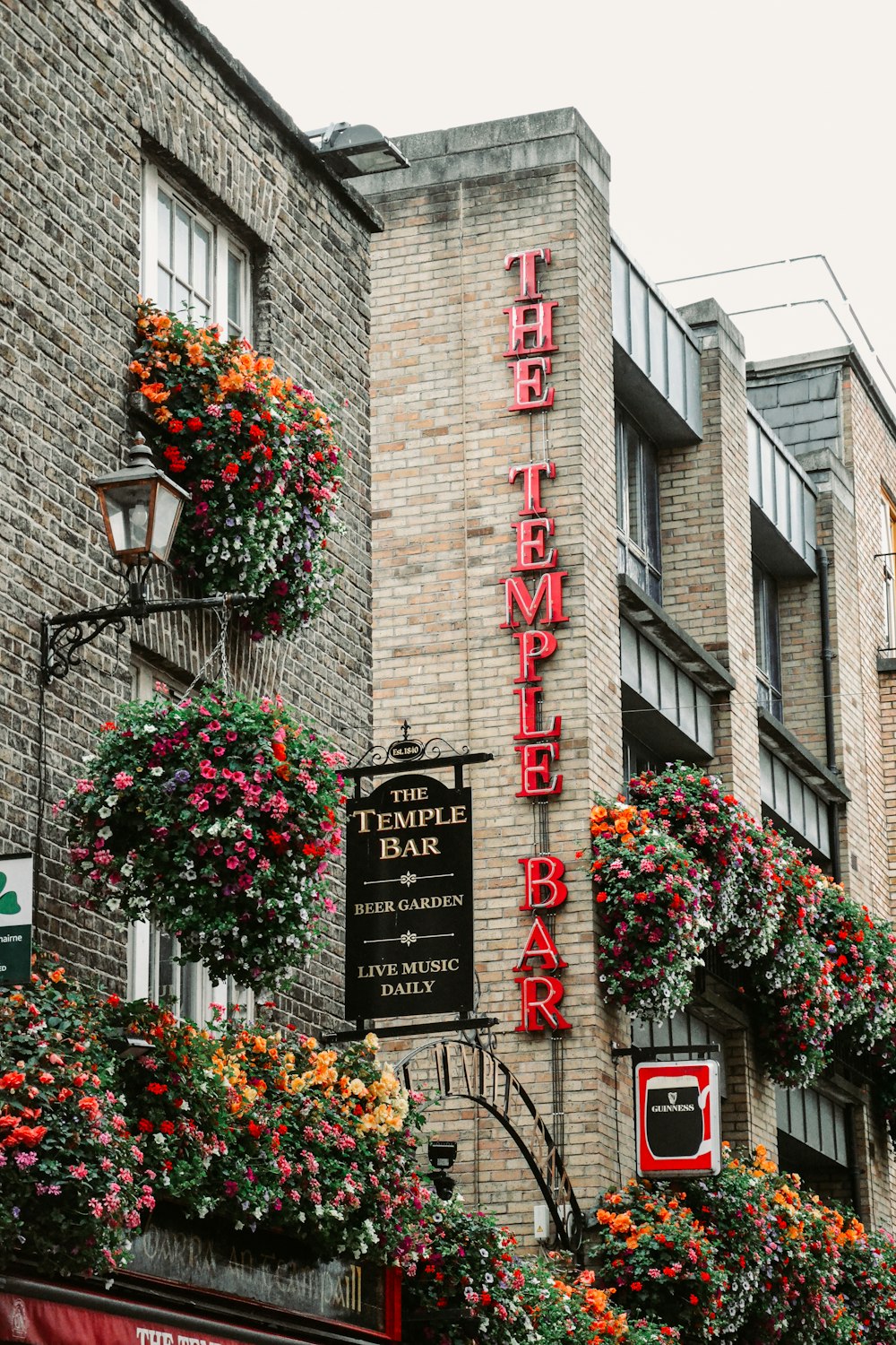 a brick building with flowers growing on the side of it