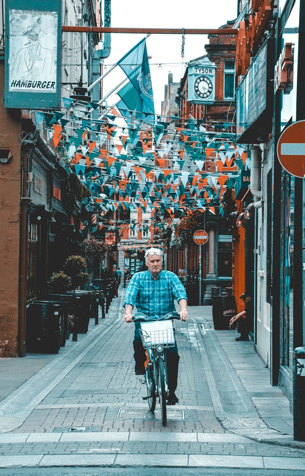 hombre con camisa de vestir a cuadros rojos y blancos y jeans de mezclilla azules montados en negro y