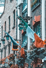 orange and green flags on black metal fence