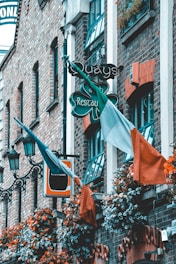 orange and green flags on black metal fence