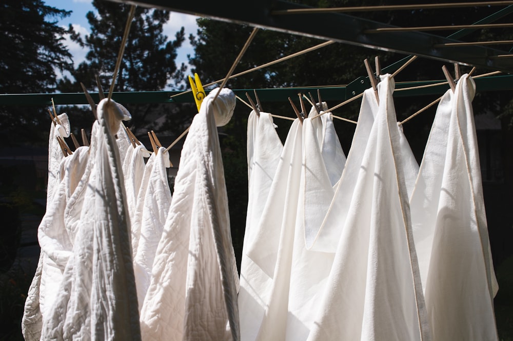 white textile hanged on wire during daytime