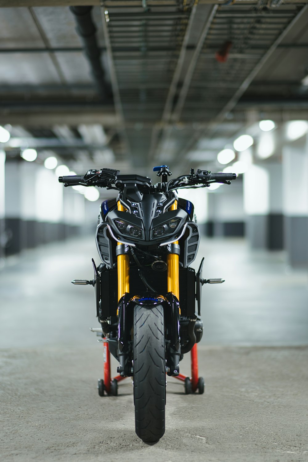 black and yellow motorcycle on a gray pavement