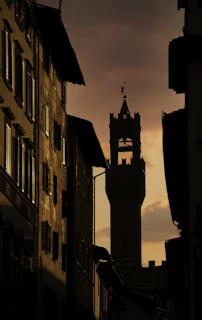 A medieval castle tower silhouette framed by a twilight sky, evoking timeless romance.