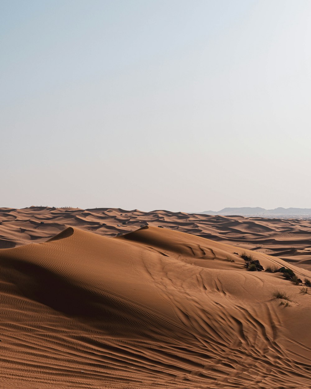 brown sand under white sky during daytime