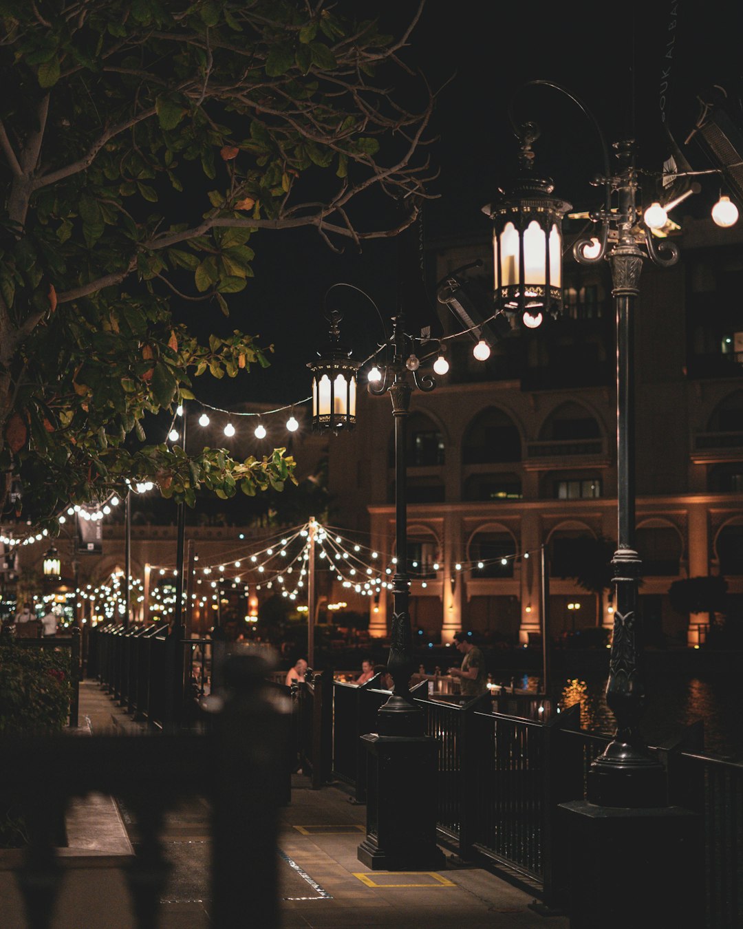 people sitting on chair near building during night time