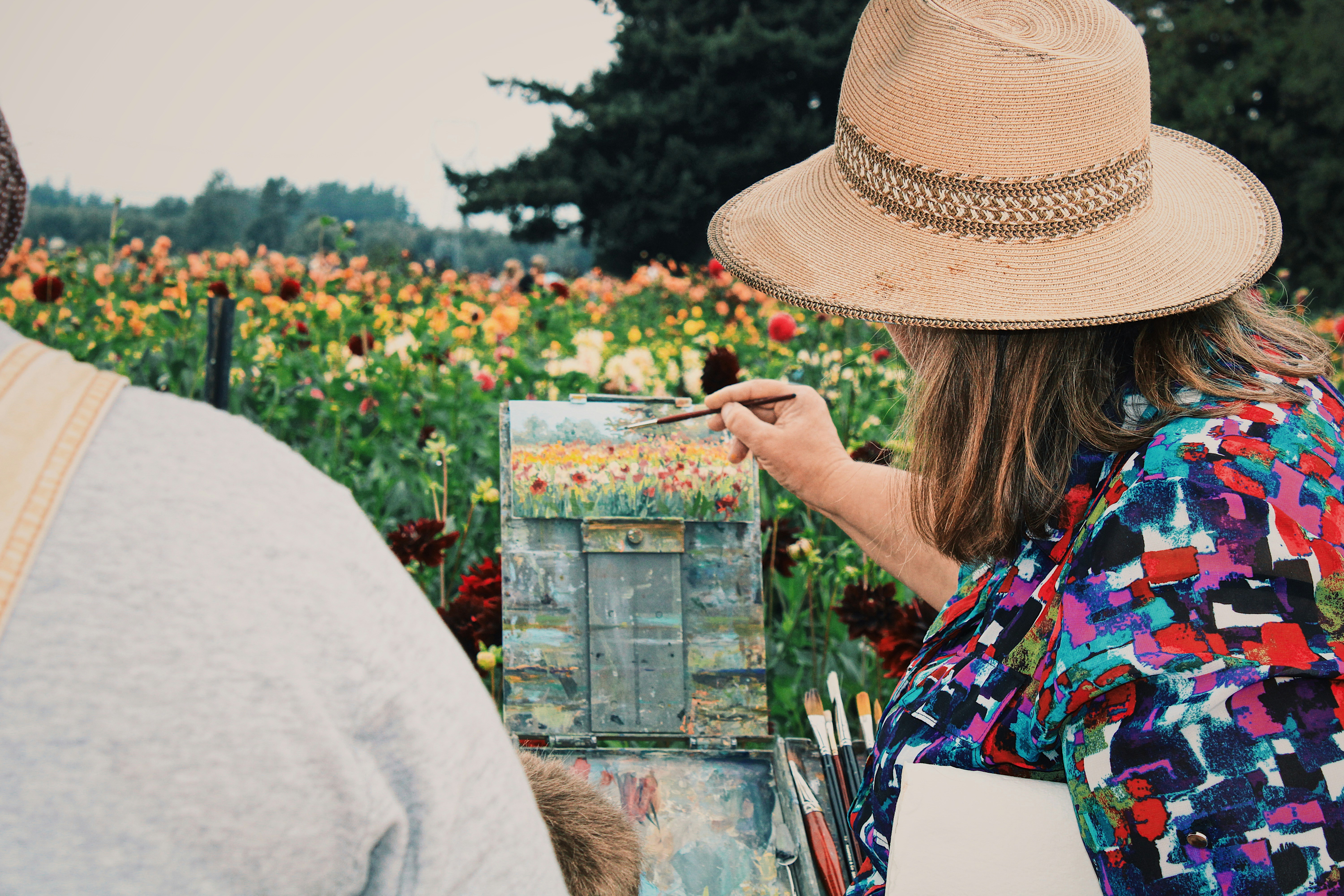 woman in white shirt holding paint brush