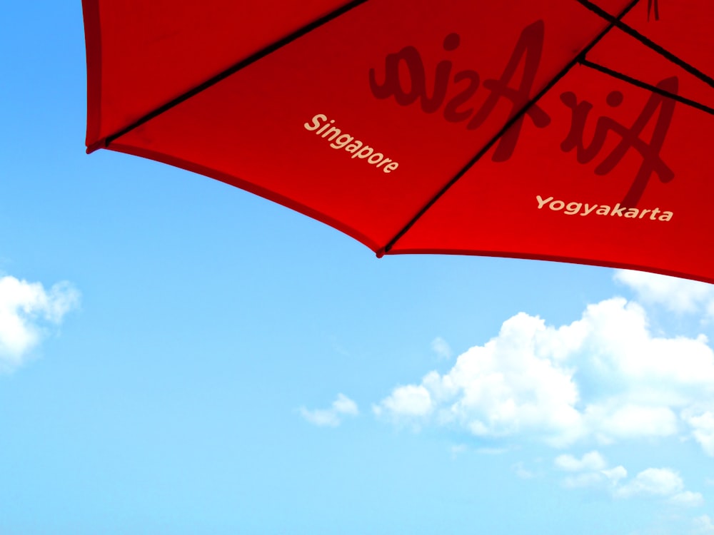 red and white umbrella under blue sky during daytime