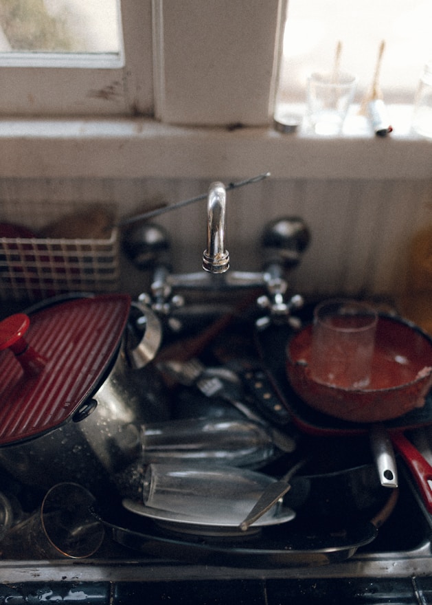 red and silver sink with faucet