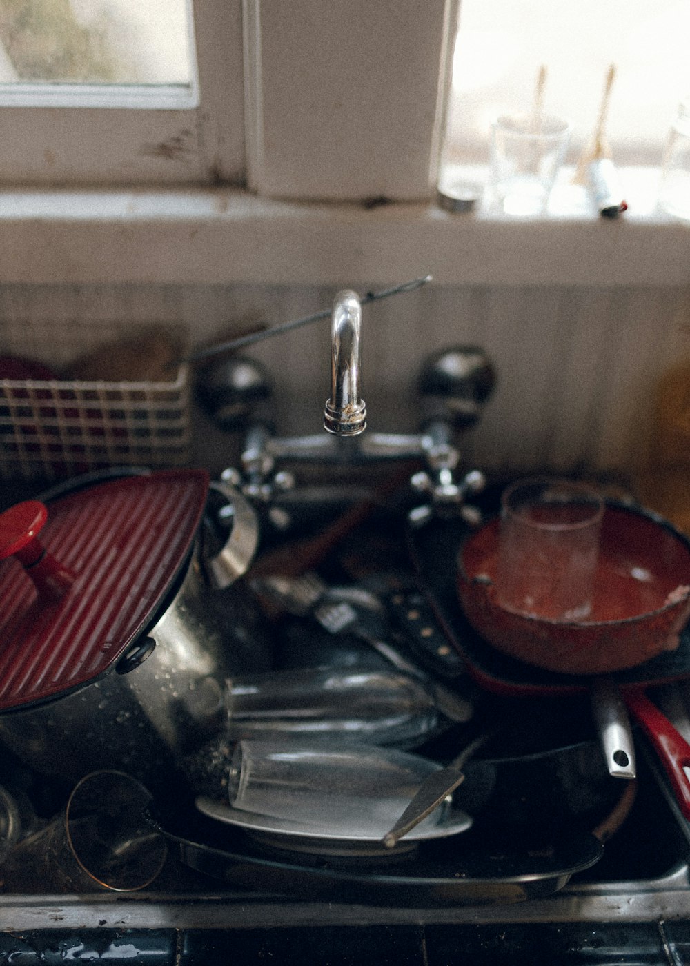 red and silver sink with faucet