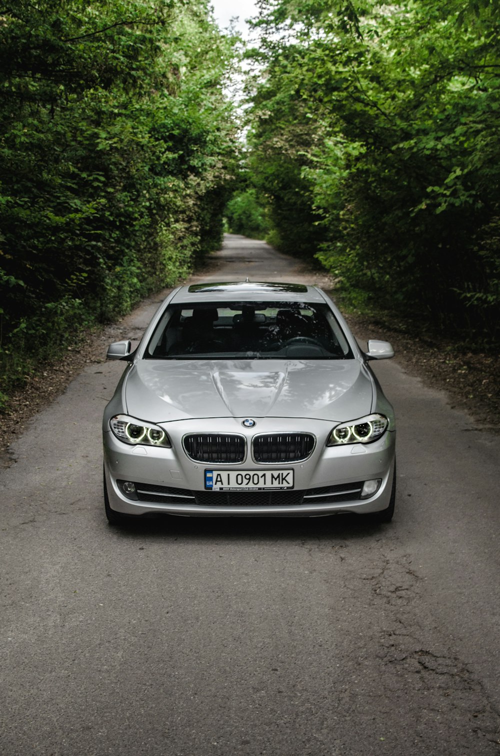 silver bmw m 3 coupe parked on dirt road