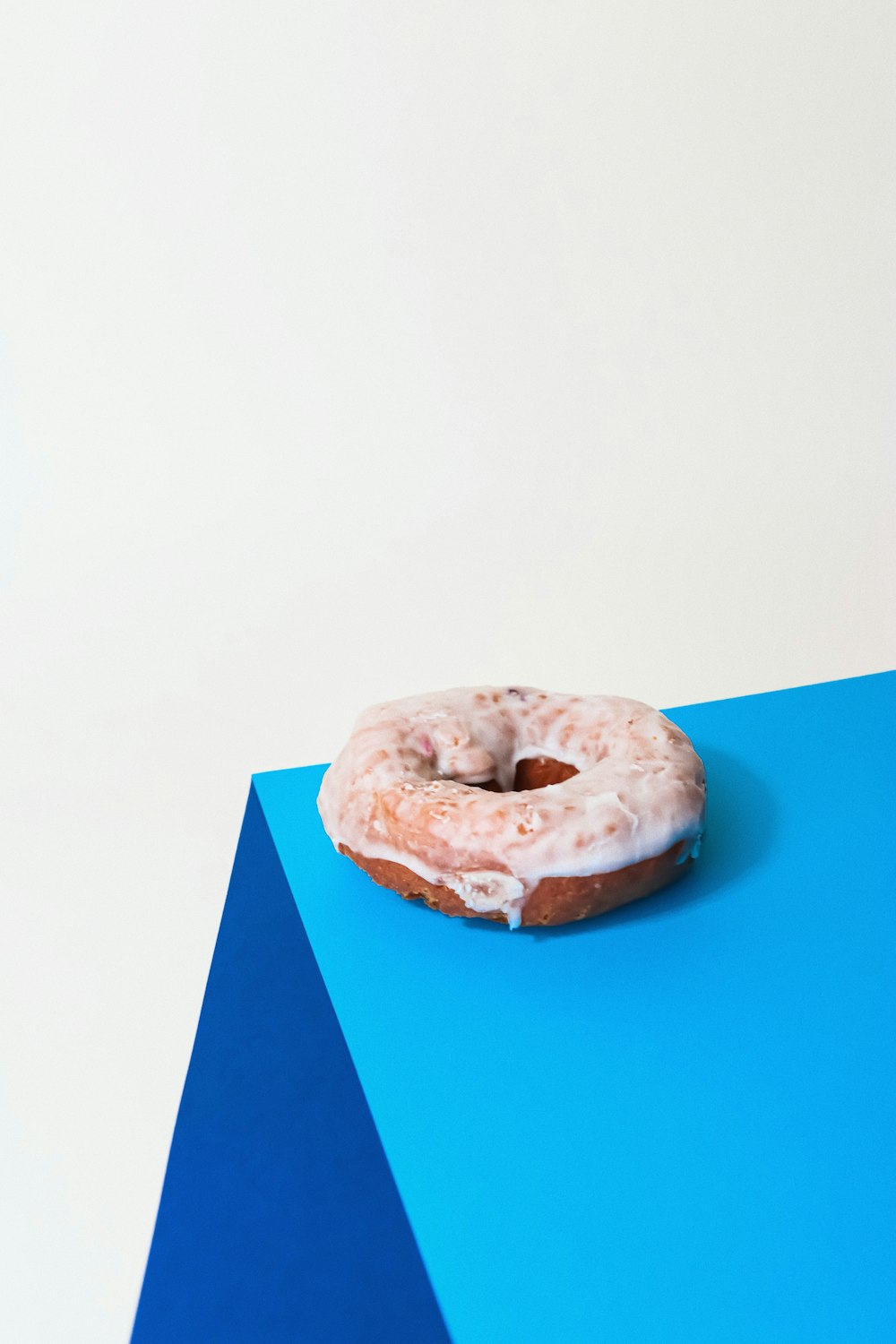 doughnut on blue paper on white table