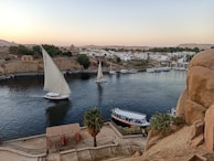 Elegant sailboats drifting peacefully on the blue waters of the Tagus River.