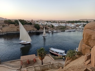 Elegant sailboats drifting peacefully on the blue waters of the Tagus River.
