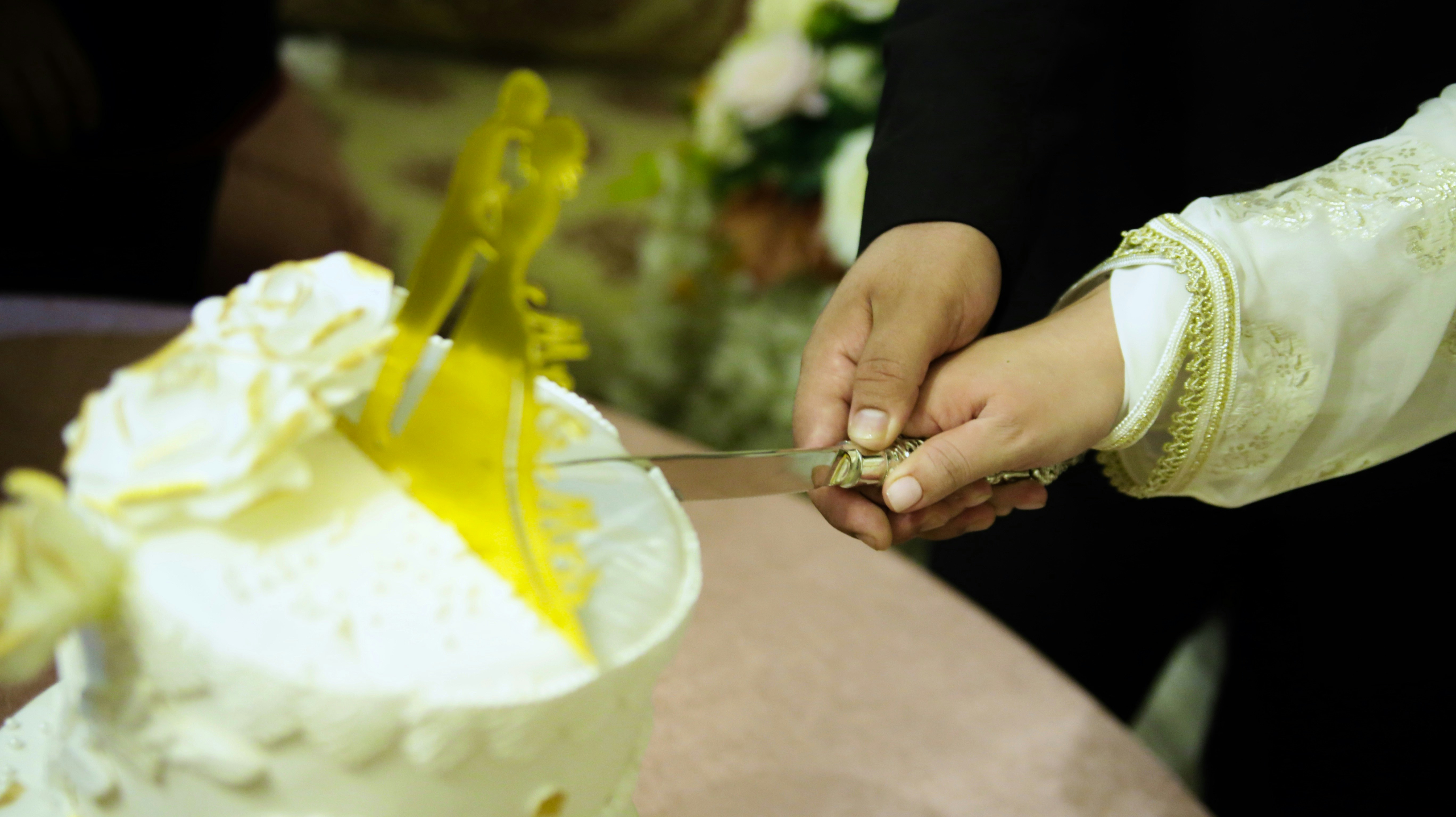 person holding silver spoon with white cream