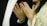 A close-up view of two hands, each wearing rings, with one hand displaying a henna design. The person on the left is dressed in a black suit with a white shirt and a red pocket square, while the person on the right is wearing a white and gold traditional outfit with intricate details.
