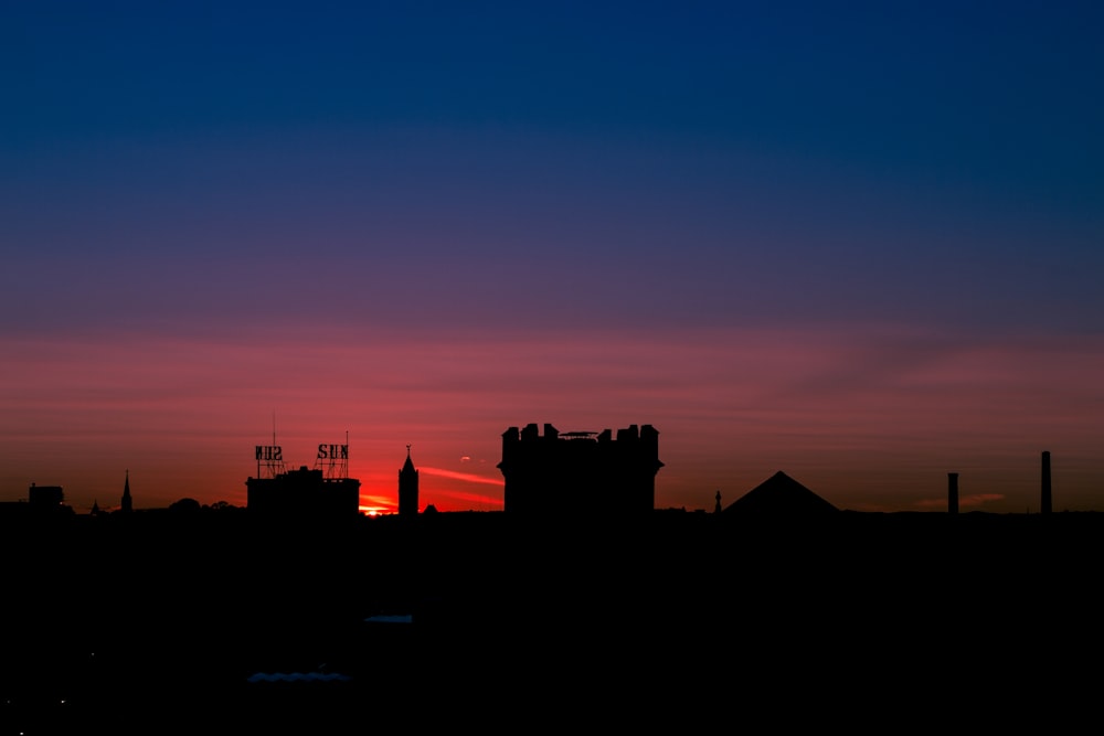 silhouette of buildings during sunset