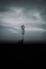 black metal tower under gray clouds