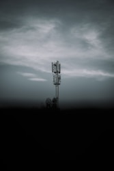 black metal tower under gray clouds
