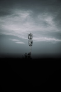 black metal tower under gray clouds