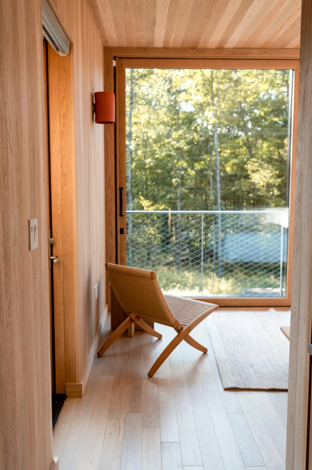 brown wooden chair near glass door