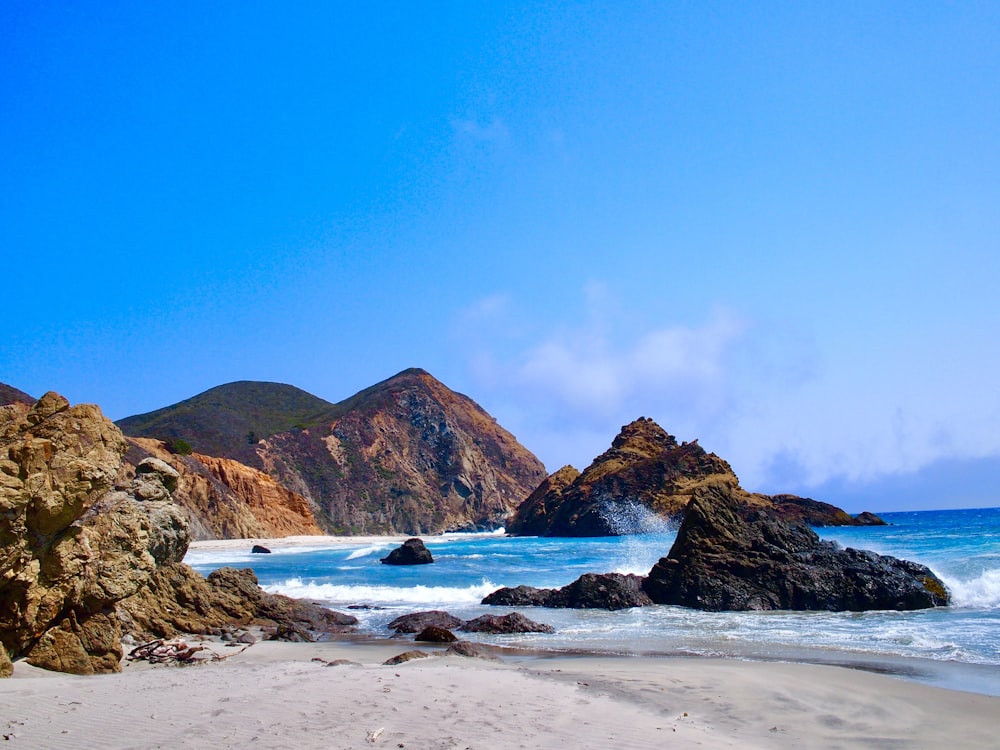 brown rock formation on sea shore during daytime