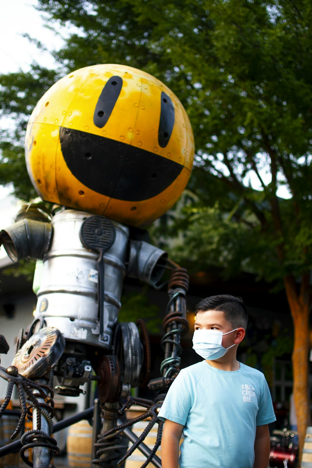 man in white shirt and gray pants holding yellow and black helmet