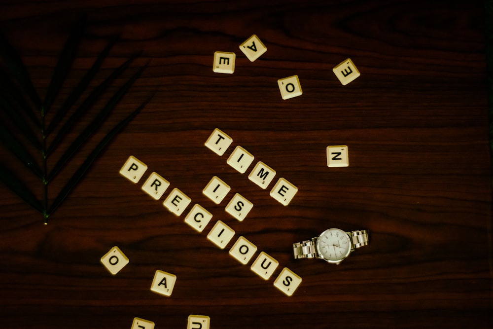 white and black letter blocks on brown wooden table