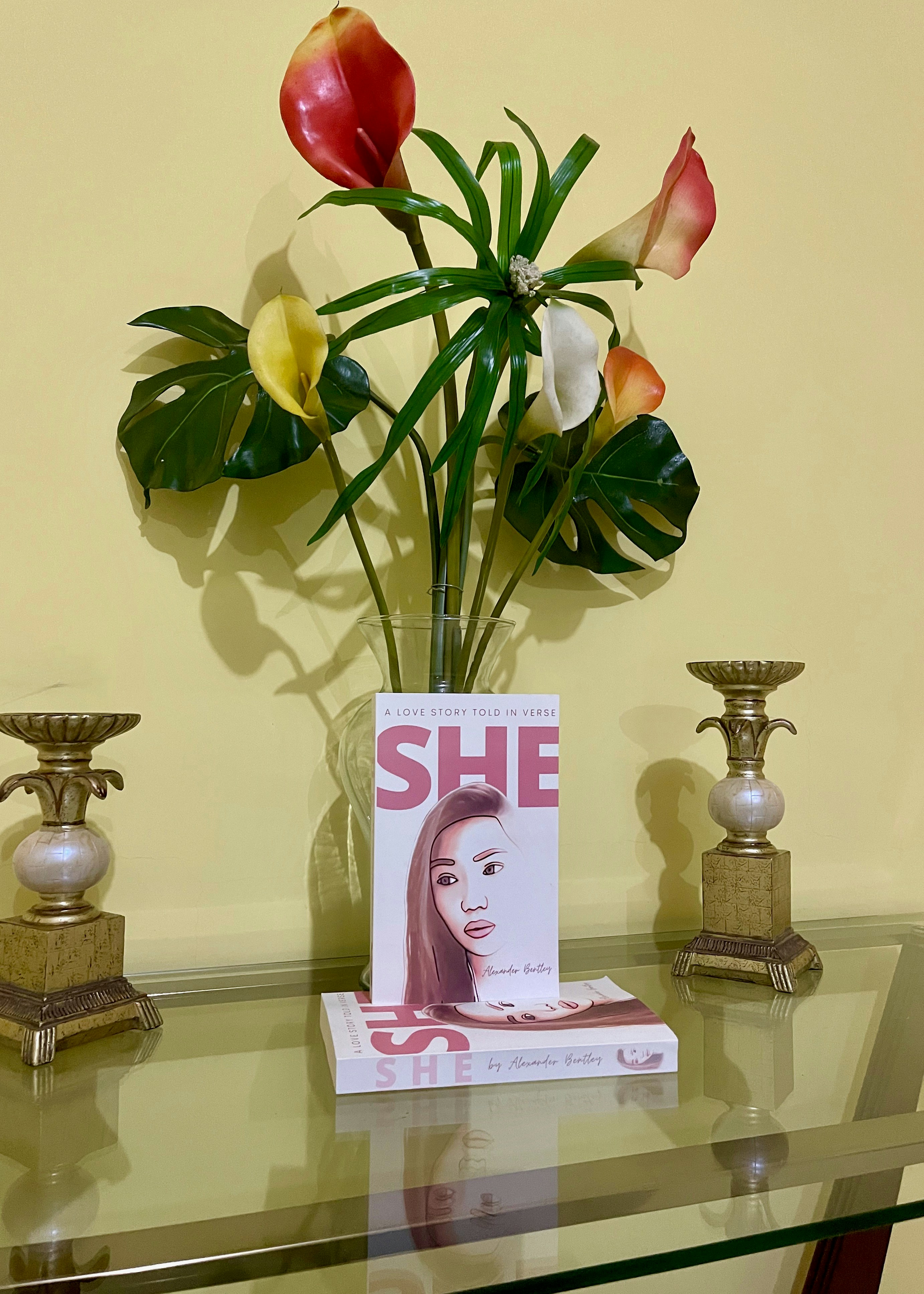 yellow rose on pink and gold colored vase