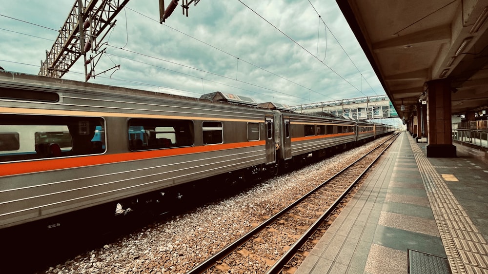 white and red train on rail tracks during daytime