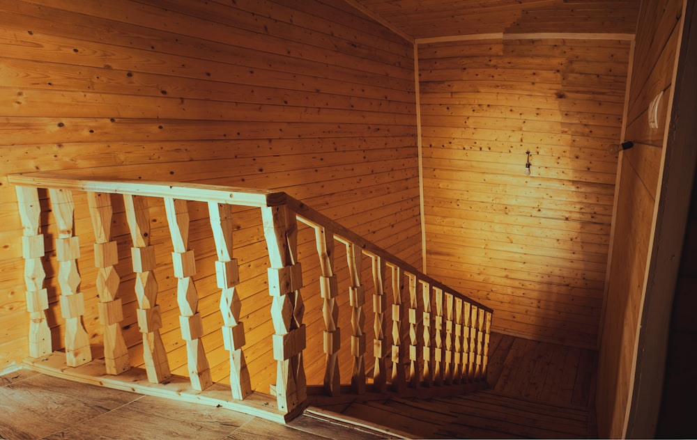 brown wooden staircase with brown wooden railings