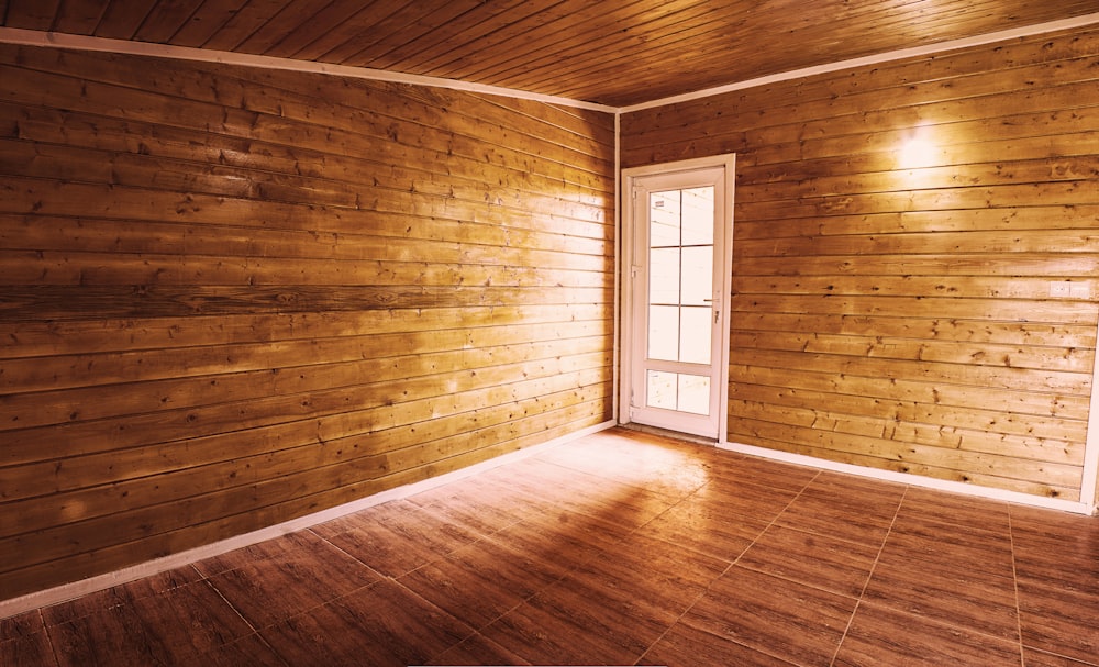 brown wooden parquet floor with white wooden framed glass window