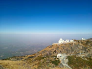 white concrete building on top of mountain during daytime