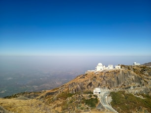 white concrete building on top of mountain during daytime
