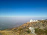 white concrete building on top of mountain during daytime
