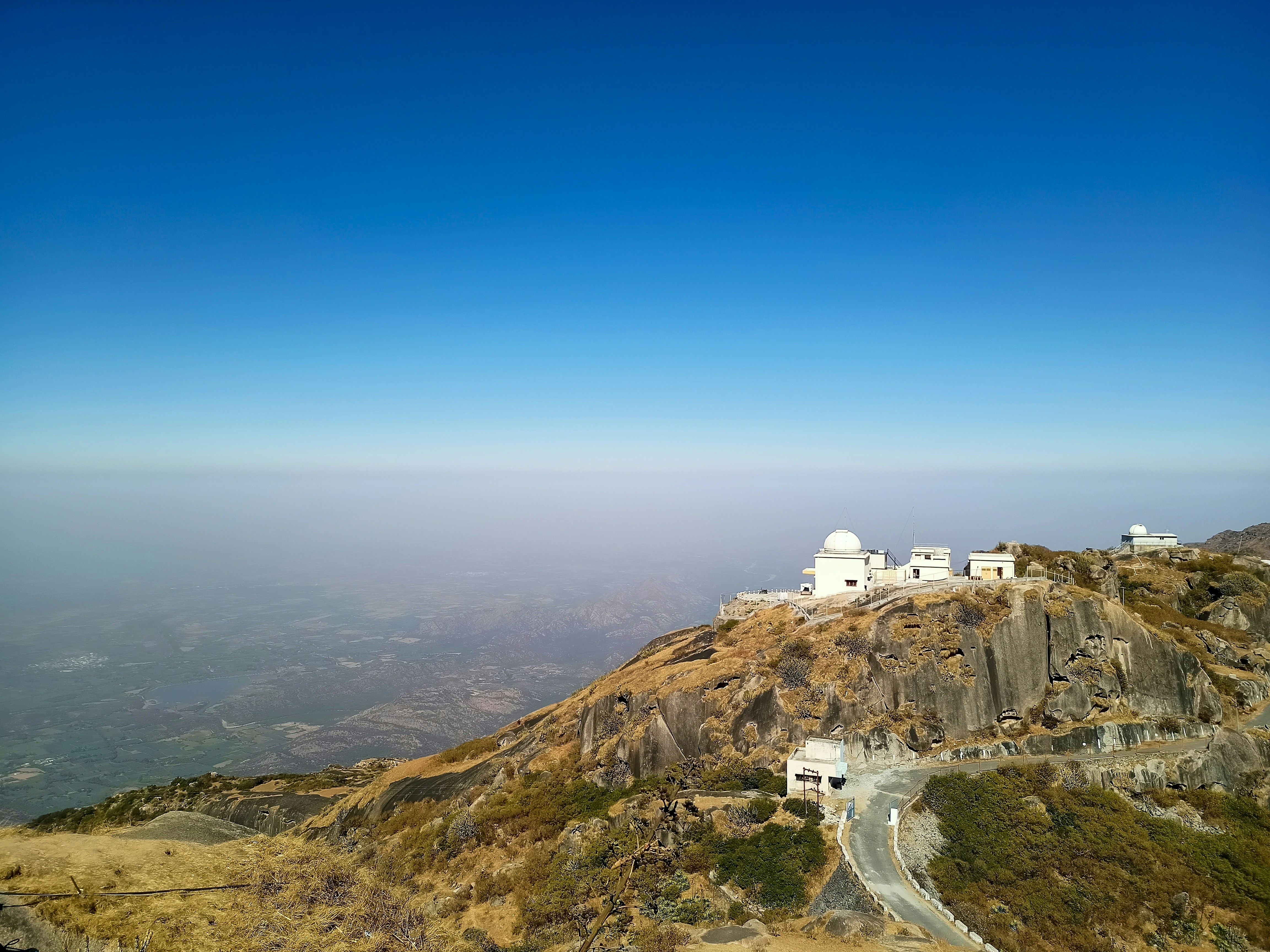 white concrete building on top of mountain during daytime