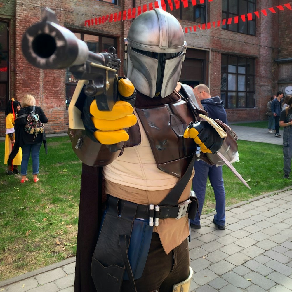 man in black and yellow power ranger costume standing on gray concrete floor during daytime