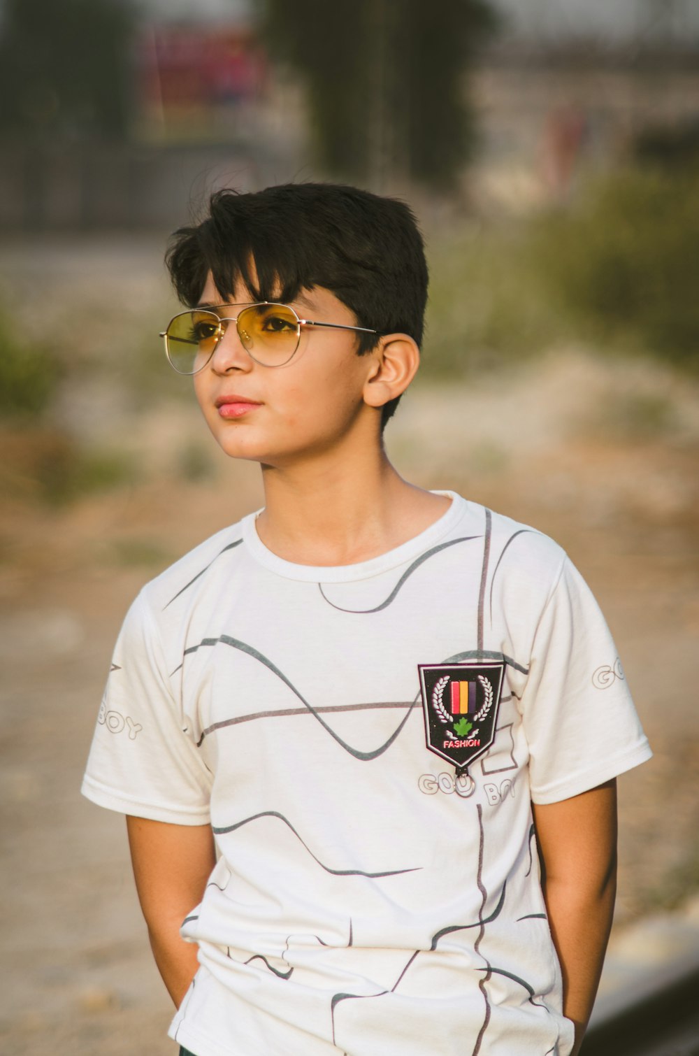 boy in white crew neck t-shirt wearing eyeglasses