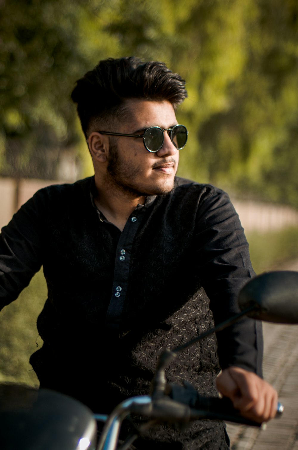 man in black jacket wearing black sunglasses