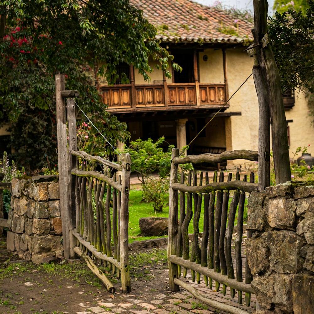 brown wooden fence near green trees during daytime