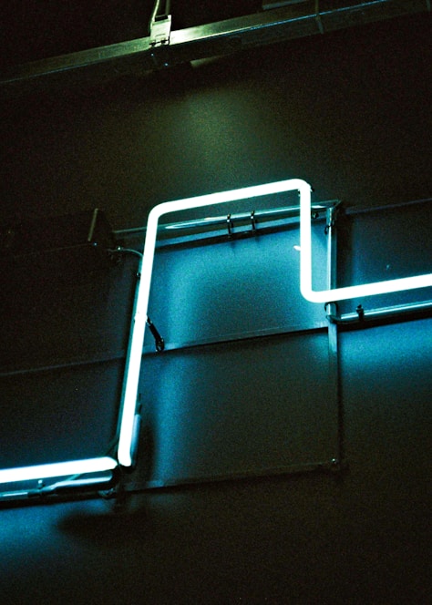 A sleek wall-mounted plasma sterilizer glowing softly in a modern hospital room.