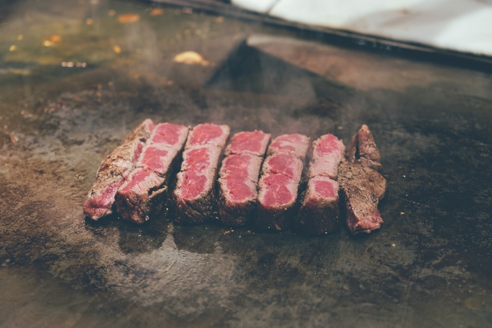 sliced meat on black surface